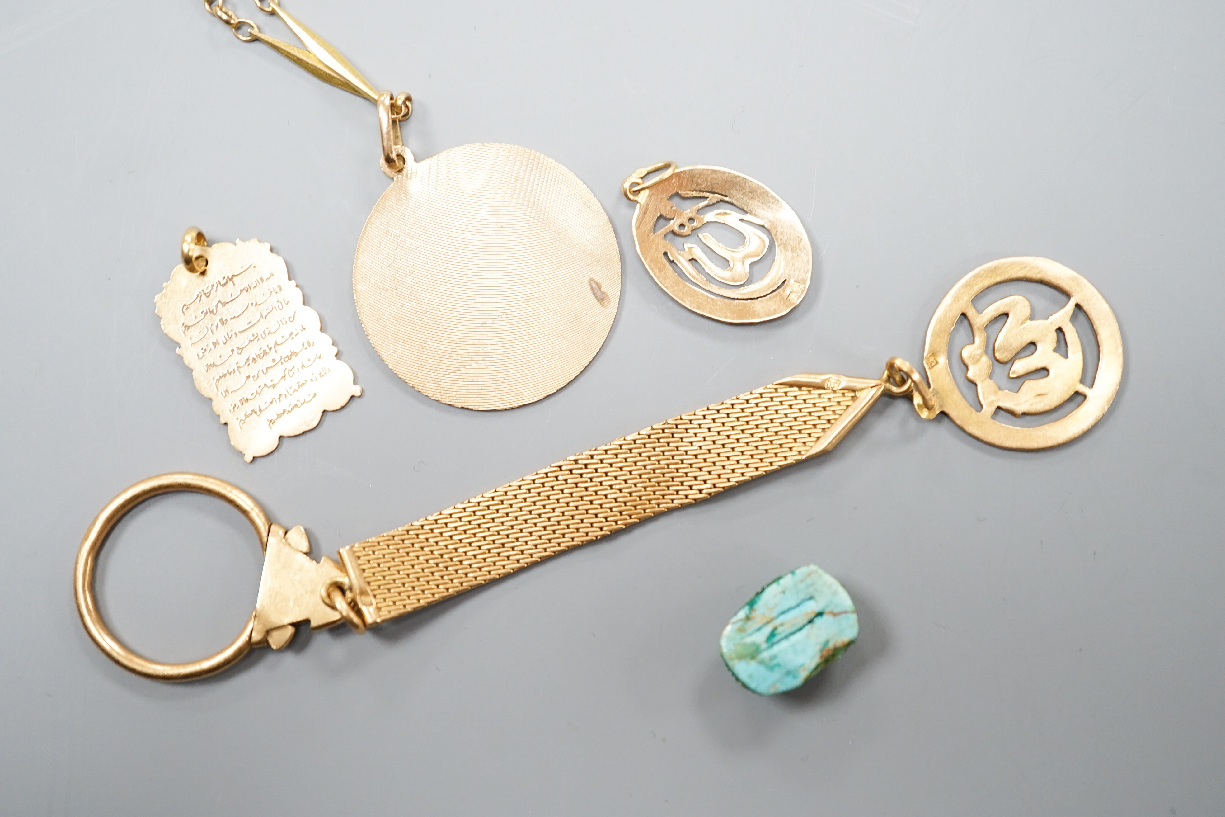 A Middle Eastern yellow metal and enamel pendant on a similar clip and three other Middle eastern pendants, one with chain, gross weight 34.5 grams and an Egyptian scarab.